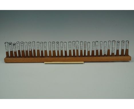 A mounted display of electroplate British army swagger stick pommels, circa 1970s