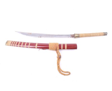 A 20th century Mandau sword and scabbard. The steel blade engraved with script, the wooden handle wrapped in string and mount