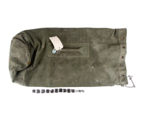 A 1953 British National Service army kit bag, musket balls and flints. The bag marked for H.W. Gregor, the balls and flints p