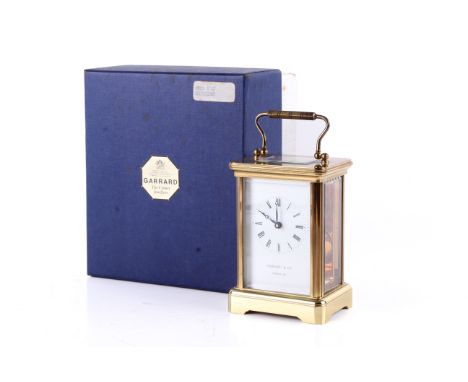 A circa 1984 Garrard & Co. Ltd. five glass carriage clock. With key, certificate of guarantee in original box. Named to the f