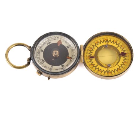 A WWI period brass Magnapole series II compass. Patent No 22598, the white face with black characters, with a plastic disc to