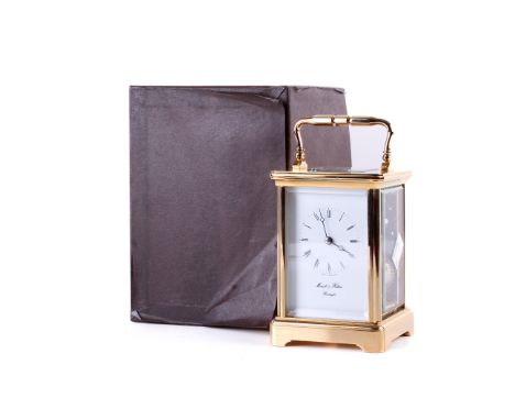 A Contemporary  Mowell and Hilton Brass Carriage clock. Maker to the face, bevelled edge to the glass. H 13.5cm W 9.5cm.