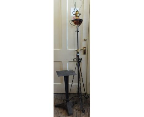 An oil lamp converted to a standard lamp and a metal table base 