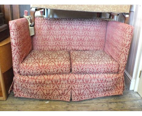 A Knowle two seater sofa with dark red floral upholstery