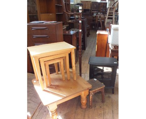 A modern wood effect electric fire, a standard lamp, a pine coffee table, a nest of tables and a small square stool