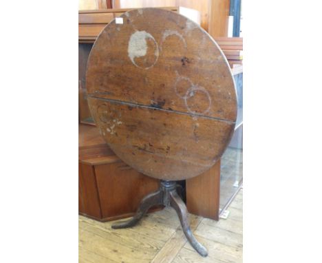 An oak tilt top circular occasional table on tripod base (split top)