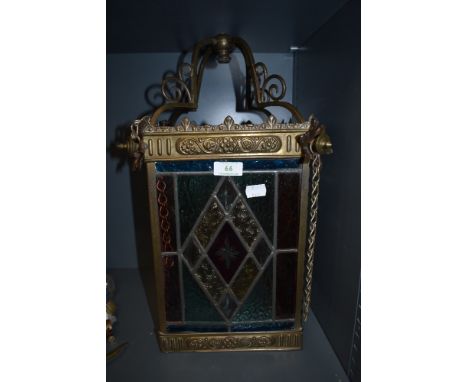 A large hallway leaded light having pressed brass body and floral designs