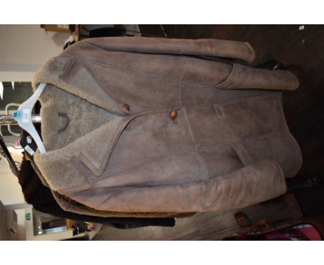 A vintage sheepskin coat having button front and pockets to sides,medium to large size.
