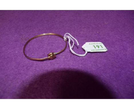 A yellow metal bangle having heart terminals, no marks tested as 9ct gold, approx 3.4g