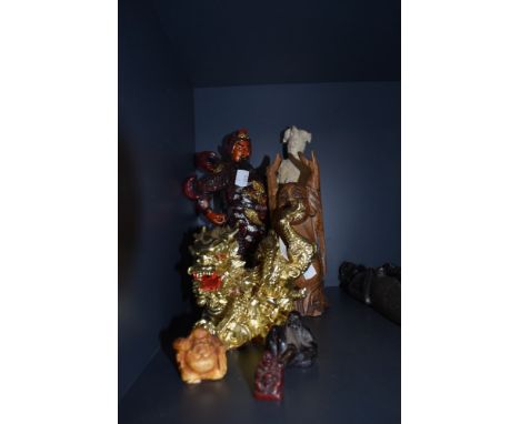 A selection of Chinese and Japanese trinkets including wooden Buddah and red resin hand carved netsuke