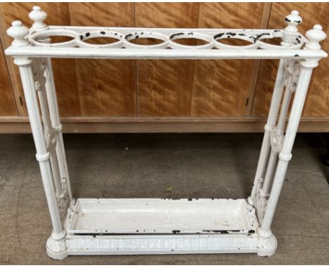 A cast iron six division stick stand, with a rectangular top with turned finials and cluster columns to a rectangular base wi