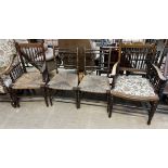 A pair of spindle back dining chairs with rush seats on turned legs together with two spindle back