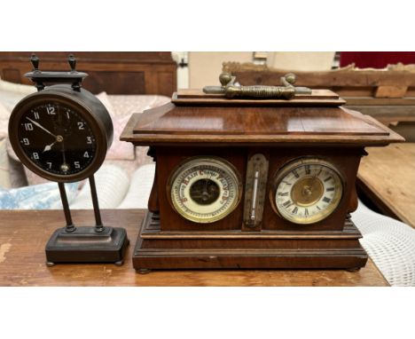 An early 20th century walnut barometer and clock combination with central mercury thermometer together with another clock