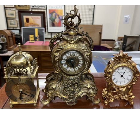 A gilt metal mantle clock together with a brass bracket type clock and another gilt mantle clock