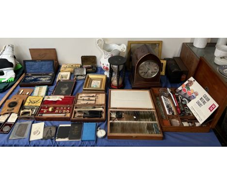 An Edwardian mahogany mantle clock of pointed form together with an hour glass, slides, hydrometer, geometry set, scalpels, p