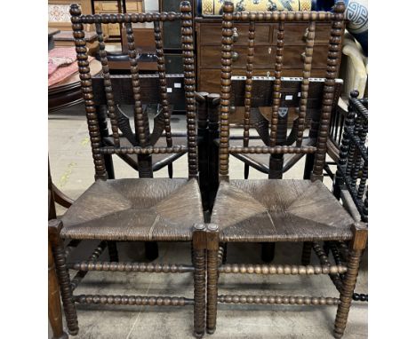 A pair of bobbin turned dining chairs, with rush seats 