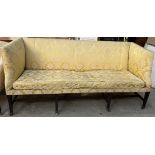 A 19th century mahogany settee with square arms and back on square tapering fluted legs and casters,