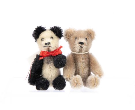 a panda with black and white mohair and a light brown mohair bear, both with metal pin eyes, black stitched noses, mouths and