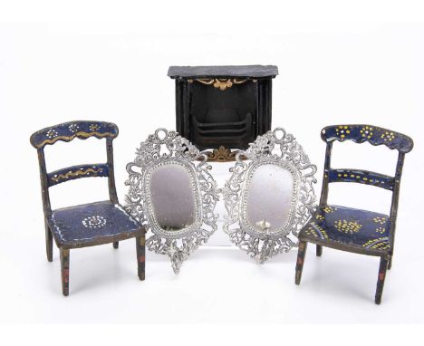 a pair of cast-iron chairs, probably American, painted dark blue with yellow, white and blue decoration —3 1/2in. (9cm.) high