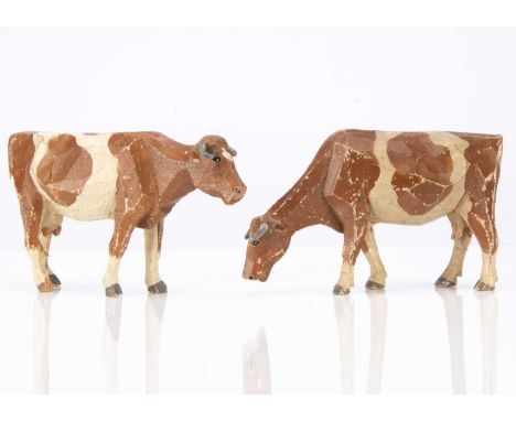 wooden, light brown and white with lead horns, one grazing, one originally with string tail —6in. (15cm.) long (both tails mi