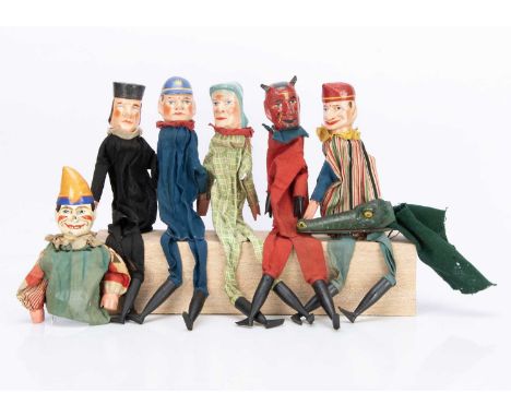 comprising Punch, Judy, Policeman, Judge and Devil with cloth bodies and wooden limbs with wooden stand —16in. (40.5cm.) high