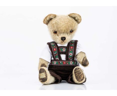with blonde mohair, orange and black plastic eyes, black stitched nose, mouth painted pads, label to foot pad --19in. (48.5cm