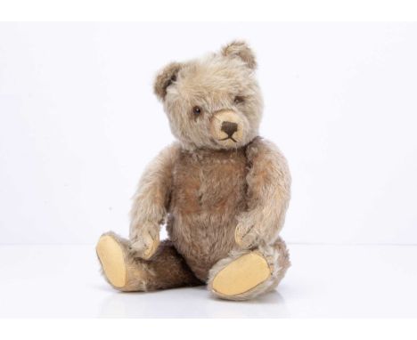 with light brown mohair, brown and black glass eyes, brown stitched nose, mouth and claws, swivel head with jointed limbs and