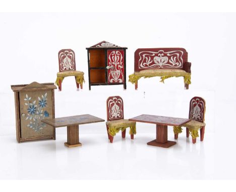 an Art Nouveau set, red stained decorated with silver, comprising a sofa —4in. (10cm.) wide, two chairs, a cupboard and a tab