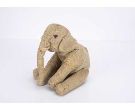 probably Steiff or Strunz, with black boot button eyes, swivel head, jointed legs, remains of stitched toes and felt tusk  --