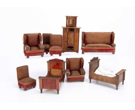 a sofa —6in. (15cm.) wide, two armchairs and three side chairs with red velvet upholstery, brass lion head arm caps and remai