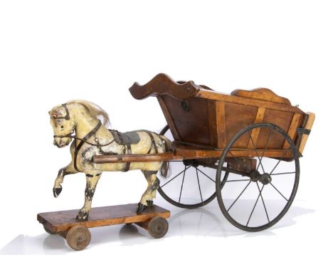 probably G & J LIne, painted dappled grey, horsehair mane and tail, leather tack, standing on platform with wooden wheels, va