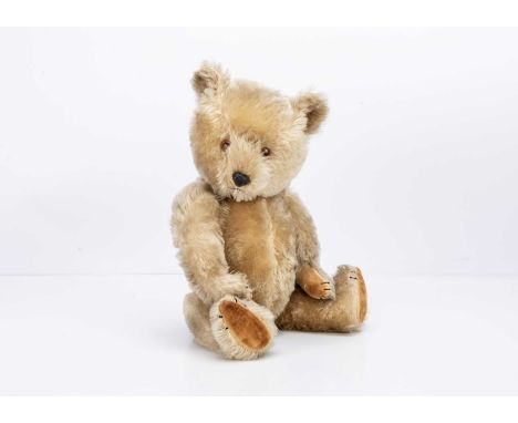 with blonde mohair, black plastic nose, black stitched mouth and claws, swivel head and jointed limbs --17in.(43cm.) high (sm