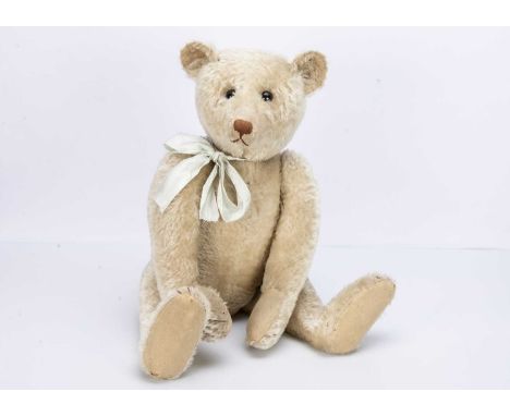 with black boot button eyes, pronounced clipped muzzle, brown stitched nose and claws, swivel head, jointed elongated limbs w