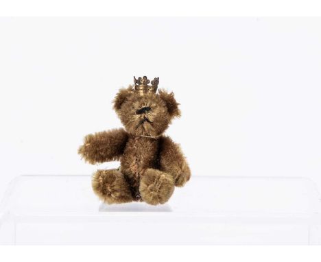 with dark golden mohair, metal pin eyes, black stitched nose, mouth and metal framed jointed body, with crown and green and y