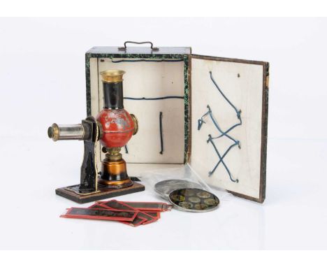 with tinplate and brass lantern on wooden stand, three circular slides and other long slides, in original wood box covered wi