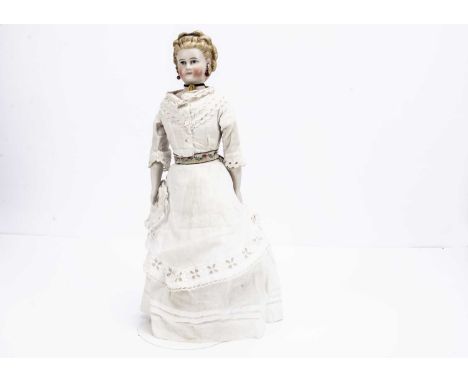 with blue paint eyes, red eyelid line, light brown brows, exposed ears pierced into the head, blonde painted and moulded hair