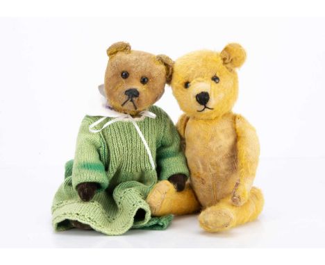 with remains of golden mohair, black boot button eyes, black stitched nose and mouth, tail-operated head mechanism and jointe
