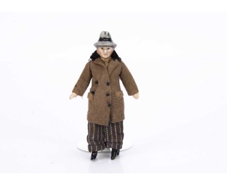 with dark painted eyes, grey moulded trilby with black band, fixed neck, jointed at shoulders and hips, brown felt overcoat w