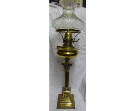 A brass Table Oil Lamp with glass shade, Corinthian column and stepped square base, 31" (79cms) high.