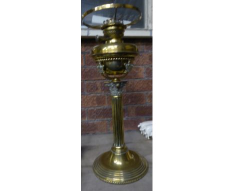 A brass Table Oil Lamp with a Corinthian column and circular foot.  19" (48cms) high.  