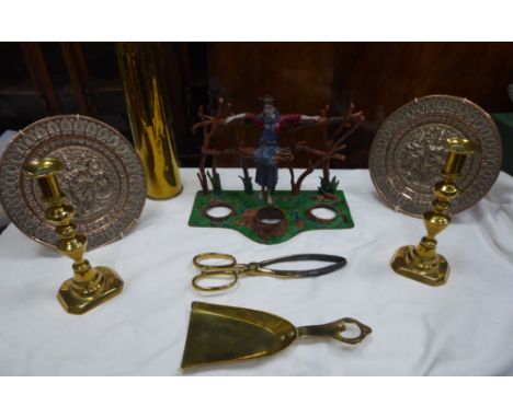 A painted wrought metal Stand with a figure of a stick gatherer by a wooden fence; a pair of Victorian brass Candlesticks, br