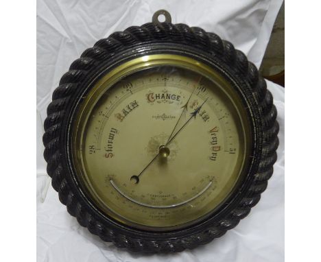 A large Aneroid Barometer and Thermometer in rope twist frame, 11" (28cms) diameter overall.