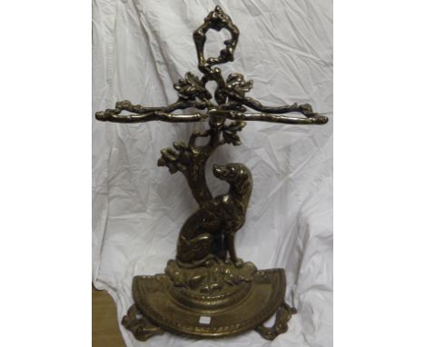 A cast metal two division Stick Stand formed as a dog seated at the base of the tree trunk, 28" (72cms) high.