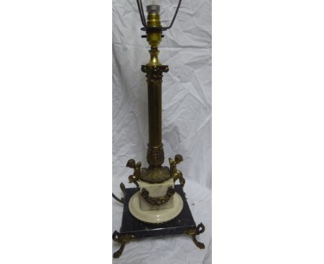A Corinthian column Table Lamp with applied cherubs and garlands, on a square marble base and paw feet, 19" (48cms) high.