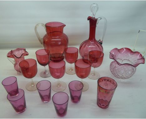 A cranberry glass Jug with reeded handle, 8" (20cms) high; a cranberry Claret Jug, cranberry Lamp Shade, and other items incl