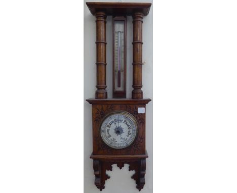An Aneroid Barometer and Thermometer in incised oak case, 27" (69cms) high. 