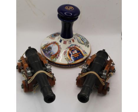 Pusser's Rum 'British Navy' style porcelain decanter, together with collection of six detailed model cannons of varying style