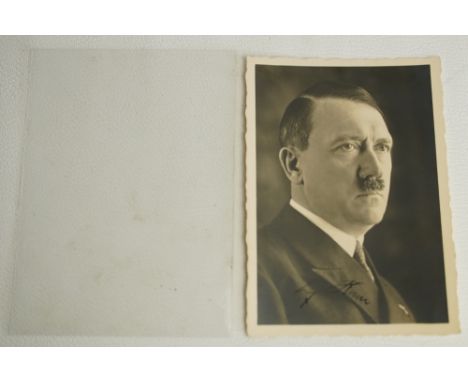 Portrait postcard depicting Adolf Hitler by Heinrich Hoffmann, C1939, with black fountain pen signature to bottom centre. SHI