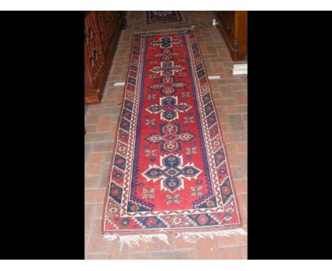 A Middle Eastern runner with geometric border