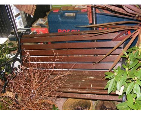 A wrought iron and wooden garden bench 